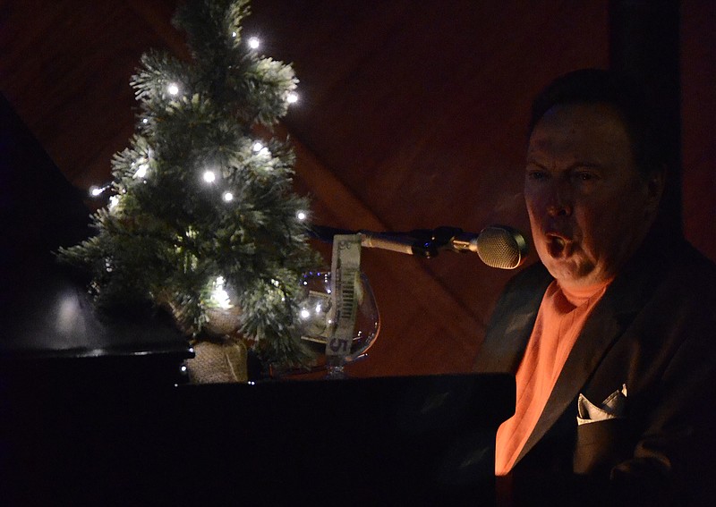 Performer Jimmy Harris plays a mix of songs, both festive and non-festive, on the piano in the Coconut Room at the Palms.