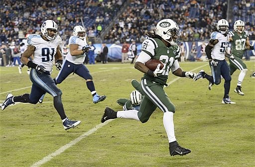 New York Jets running back Chris Johnson (21) carries the ball past Tennessee Titans defender Derrick Morgan (91) in theirl game, Sunday, Dec. 14, 2014, in Nashville.