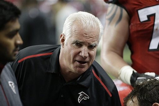 Atlanta Falcons head coach Mike Smith speaks to players on the sidelines during their game against the Pittsburgh Steelers on Dec. 14, 2014, in Atlanta. 