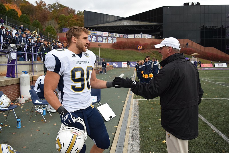 UTC defensive end Davis Tull is congratulated by head coach Russ Huesman in the final seconds of the Southern Conference champions' 51-0 victory at Western Carolina. Tull is a three-time SoCon defensive player of the year who Monday was announced as an AFCA All-American for the third time as well.