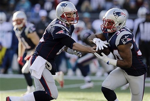New England Patriots quarterback Tom Brady (12) hands off to running back Shane Vereen (34) in the first half of an NFL football game against the Miami Dolphins on Sunday, Dec. 14, 2014, in Foxborough, Mass.