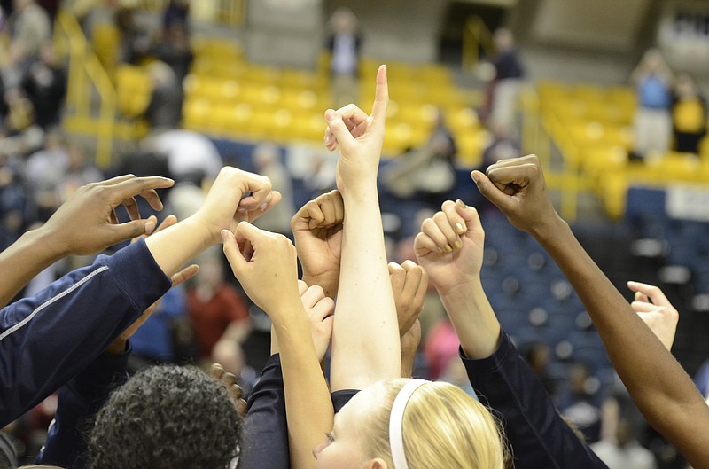 UTC players huddle up in celebration after a 54-46 UTC victory against Stanford at McKenzie in Chattanooga, Tenn., on Wednesday, December 17, 2014.