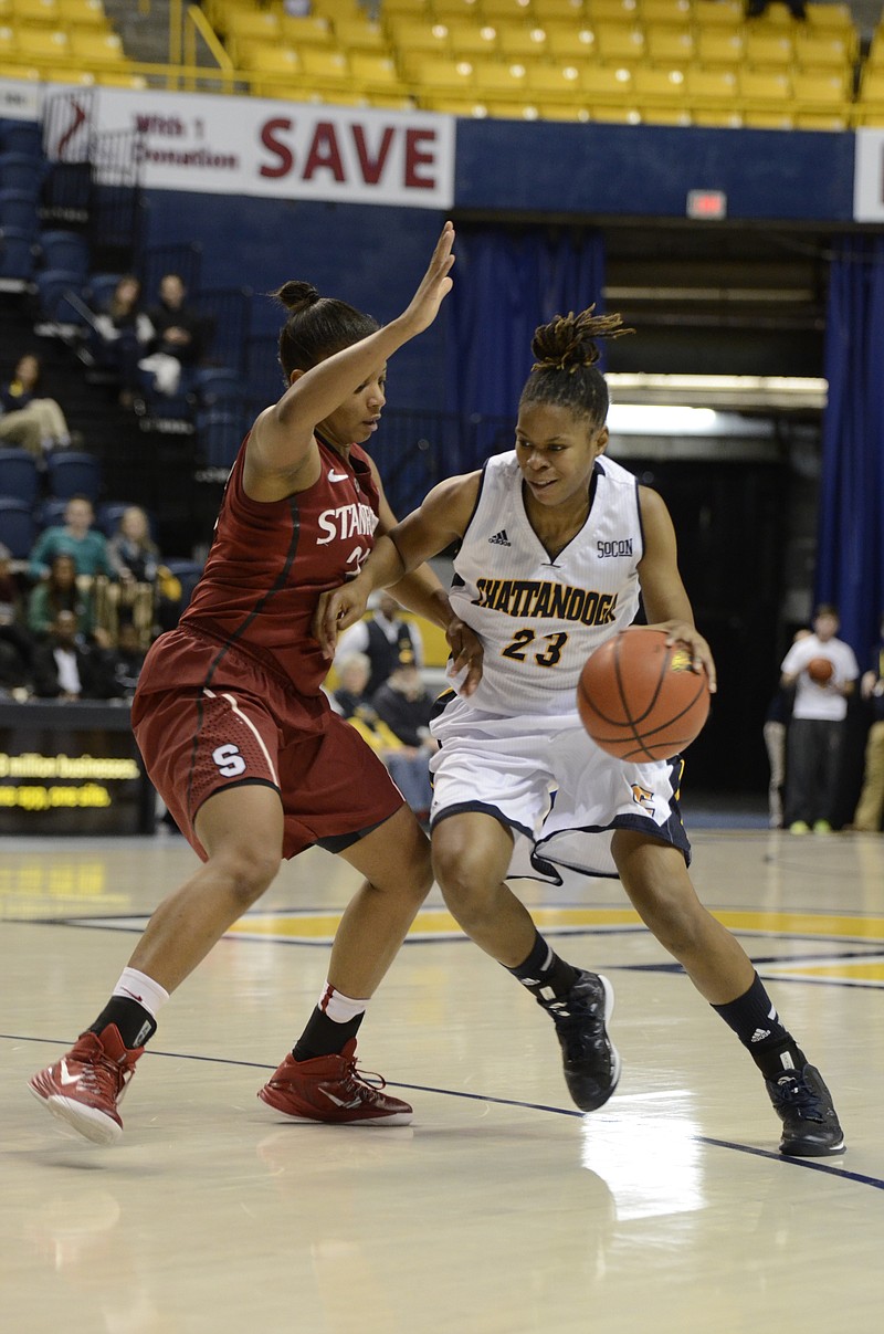 UTC's Moses Johnson (23) drives in towards the basket against Amber Orrange (33). Johnson scored 10 points for the Mocs during a 54-46 UTC victory against Stanford at McKenzie in Chattanooga, Tenn., on Wednesday, December 17, 2014.