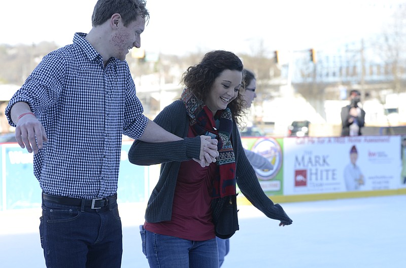 UTC students Ross McClellon, 22, and Kristan Cartwright, 21, are all smiles as they skate at Ice on the Landing. They are among about 6,000 people who have tried out the 50-by-70-foot outdoor rink since it opened less than a month ago at Ross’s Landing.