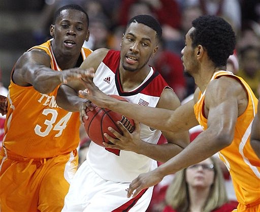 North Carolina State's Ralston Turner pulls in a rebound between Tennessee's Devon Baulkman, left, and Derek Reese during the second half of N.C. State's 83-72 victory in Raleigh, N.C., Wednesday, Dec. 17, 2014.