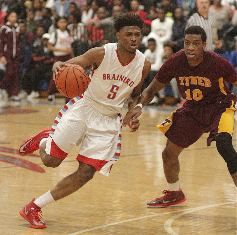 Brainerd's Marques Tipton (5) drives around Tyner's Daaron Maston Thursday at Brainerd High School.