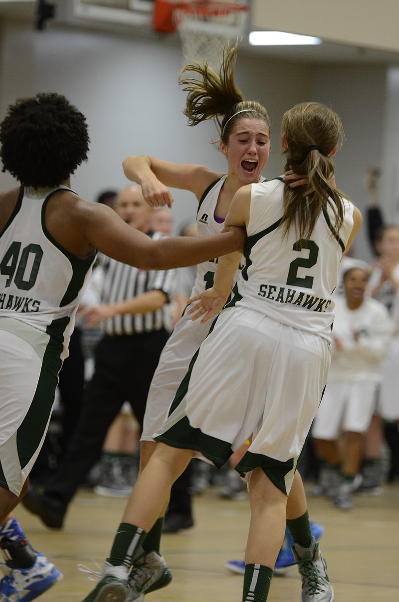 Silverdale's Rachel Sanders (40) and Emily Harkleroad (11) congratulate Megan Lewis (2) who made the game-winning 3-point shot in overtime to defeat Boyd-Buchanan 45-44 Thursday at Silverdale High School.