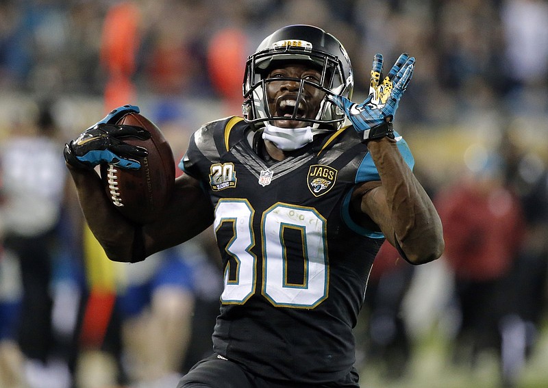 
              Jacksonville Jaguars running back Jordan Todman (30) smiles as he runs 62 yards for a touchdown against the Tennessee Titans during the fourth quarter of an NFL football game Thursday, Dec. 18, 2014, in Jacksonville, Fla. (AP Photo/Stephen B. Morton)
            