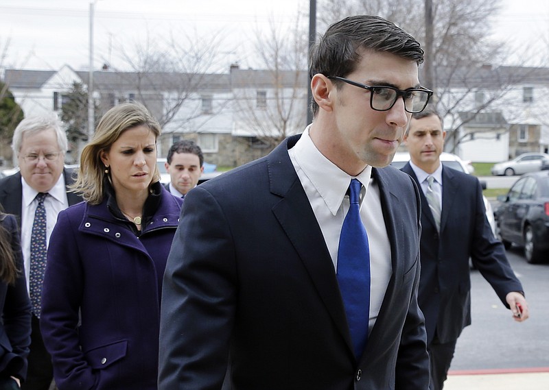 
              Olympic swimmer Michael Phelps walks into a courthouse for a trial on drunken driving and other charges, Friday, Dec. 19, 2014, in Baltimore. Documents show that the 29-year-old was leaving Baltimore's Horseshoe Casino Sept. 30 when he was pulled over for speeding and crossing the double yellow line on a highway. Police say Phelps registered a .14 per cent on a blood-alcohol test. The legal limit to drive is .08 per cent in Maryland. (AP Photo/Patrick Semansky)
            