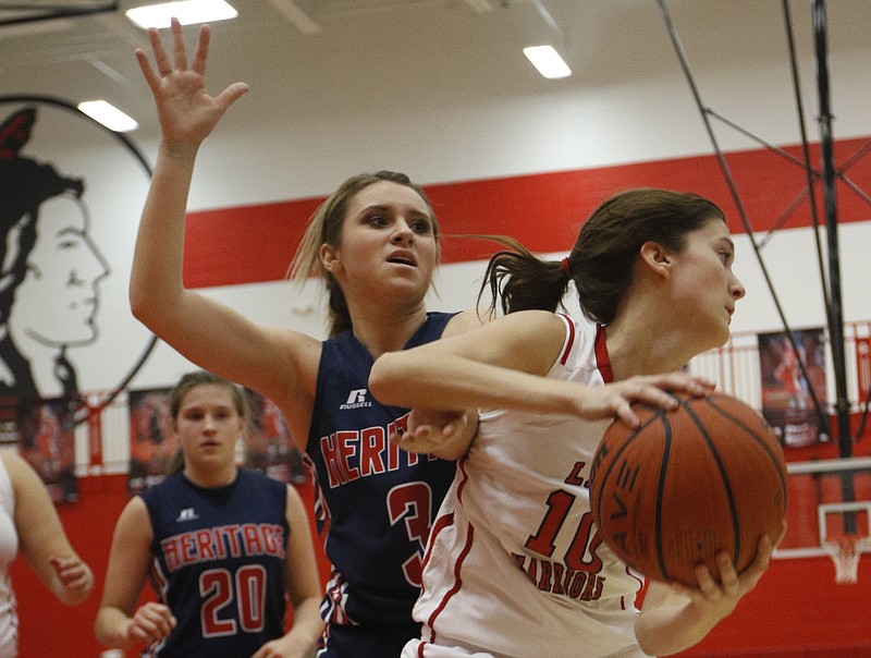 LFO's Abbi Mabry, right, tries to clear the ball away from Heritage's Tori Harvey during their prep basketball game Friday, Dec. 19, 2014, at Lakeview-Fort Oglethorpe High School in Fort Oglethorpe, Ga. 