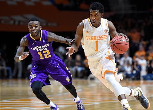 Tennessee guard Josh Richardson (1) drives past Tennessee Tech guard Mitchell Hill (12) during their game in Knoxville on Friday, Dec. 19, 2014. 