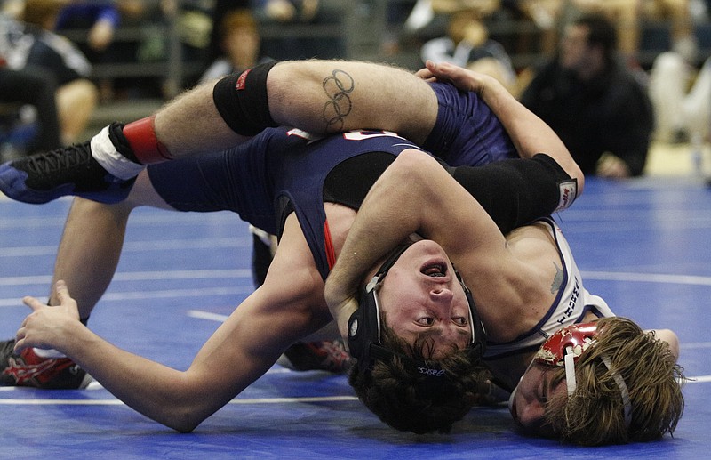 Heritage's Charles Thurman, right, tries to pin Brentwood Academy's Justin Becci during their 120 lb championship bout in the McCallie Invitational high school wrestling tournament Saturday, Dec. 20, 2014, at McCallie School in Chattanooga, Tenn. Thurman won the bout and took first place.