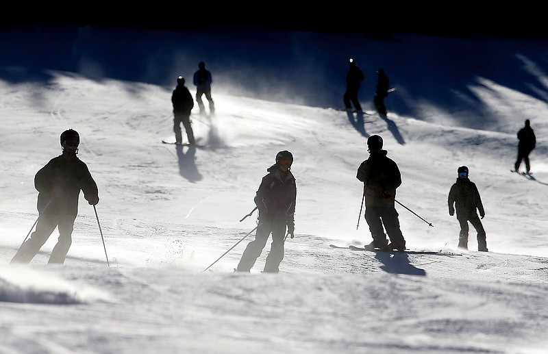 Skiers and snowboarders take a run at Breckenridge in Colorado. Business is booming in Colorado's mountain resorts, and the addition of recreational marijuana stores this year has attracted droves of customers curious about legalized pot. 