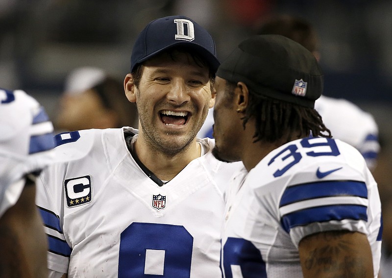 
              Dallas Cowboys quarterback Tony Romo, left, laughs as he talks with teammate Brandon Carr (39) on the sideline during the second half of an NFL football game against the Indianapolis Colts, Sunday, Dec. 21, 2014, in Arlington, Texas. (AP Photo/Brandon Wade)
            