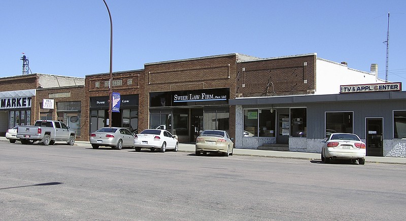 
              This June 12, 2014 photo shows the new Swier Law Firm nestled between businesses in Corsica, S.D., a rural town of 600. A program in South Dakota is helping to lure attorneys from big cities to sparsely populated areas. Although federal grant money for decades has been available for doctors, nurses and dentists willing to relocate to sparsely populated areas, the South Dakota program is believed to be the first of its kind to similarly compensate lawyers. (AP Photo/Regina Garcia Cano)
            