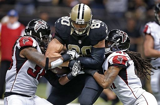 Atlanta Falcons strong safety Kemal Ishmael (36) strips the football from New Orleans Saints tight end Jimmy Graham (80) after a reception near the goal line in their game in New Orleans, Sunday, Dec. 21, 2014. 