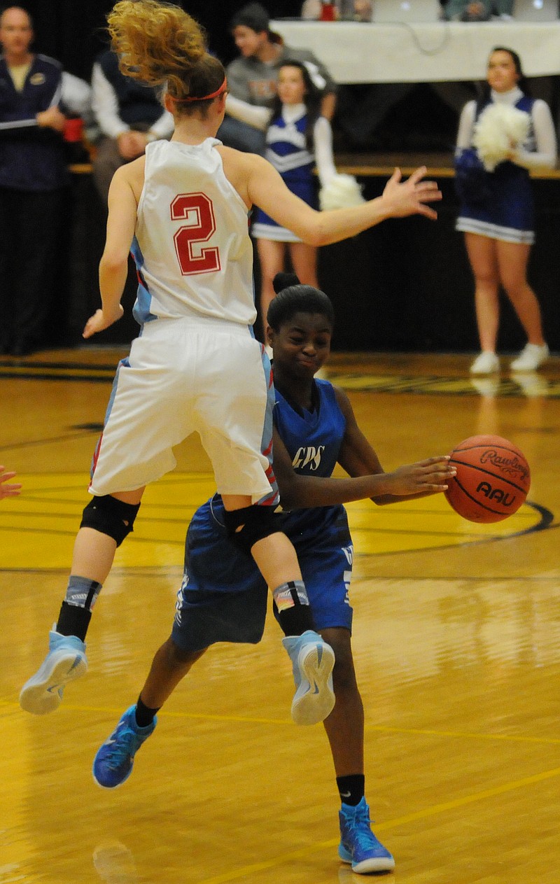 Maryville Heritage's Mikayla Hutsell (2) jumps to block a pass from GPS's Jameshia Dunegan (12) in first half action  Monday in the EPB Fiber Optic Holiday Tournament at Hixson High School.