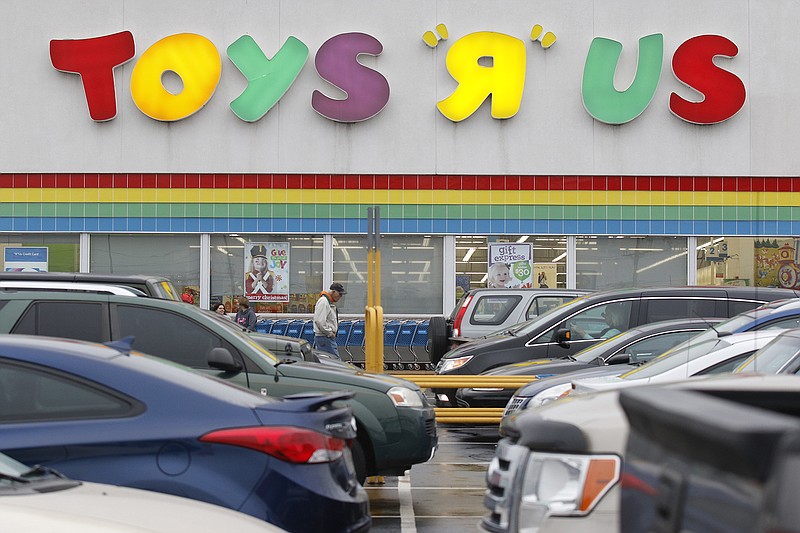 A shopper walks past the Toys R Us in Hixson on Tuesday. The store will be closing at the end of January.