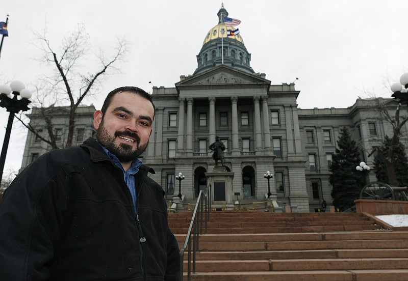 
              In this Tuesday, Dec. 23, 2014 photo, Edgar Antillon, one of the organizers of an effort to have a ballot measure placed before voters in the 2016 November election to allow marijuana users to carry concealed firearms, stands outside the State Capitol, in downtown Denver. The measure would change state law to prevent sheriffs from using marijuana use as a reason to deny a concealed carry permit to an applicant. (AP Photo/David Zalubowski)
            