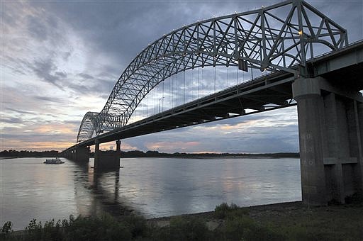 FILE - In this July 13, 2012, file photo, the Memphis Queen riverboat approaches the I-40 bridge spanning the Mississippi River at Memphis, Tenn. The FBI on Tuesday, Dec. 23, 2014, asked law officers assigned to areas around the Mississippi River bridges at Memphis to help keep an eye on the spans after a vague threat came in warning of an attack. (AP Photo/Nikki Boertman, File)