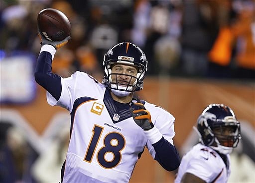 Denver Broncos quarterback Peyton Manning throws during the first half of an NFL football game against the Cincinnati Bengals on Monday, Dec. 22, 2014, in Cincinnati. 