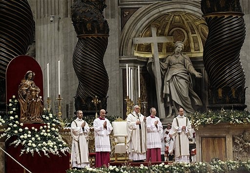 Pope Francis, center, celebrates the Christmas Eve Mass in St. Peter's Basilica at the Vatican, Wednesday, Dec. 24, 2014. 