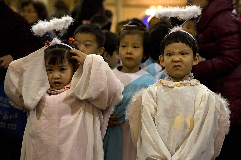 Children dressed as angels take part in a mass on the eve of Christmas at the South Cathedral official Catholic church in Beijing, China, Wednesday, Dec. 24, 2014. Estimates for the number of Christians in China range from the conservative official figure of 23 million to as many as 100 million by independent scholars, raising the possibility that Christians may rival in size the 85 million members of the ruling Communist Party.