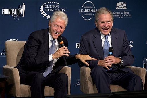 Former Presidents Bill Clinton, left, and George W. Bush, as they laugh together during the Presidential Leadership Scholars Program Launch, at The Newseum in Washington in this Sept. 8, 2014, file photo.