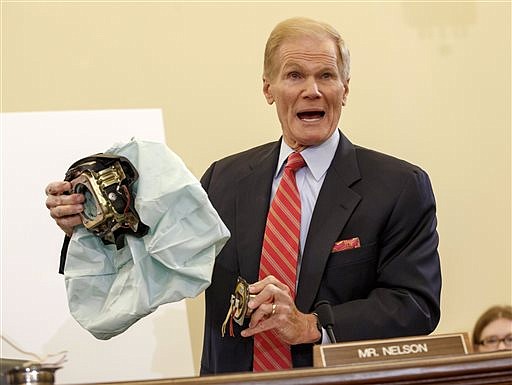 U.S. Senate Commerce Committee member Sen. Bill Nelson, D-Fla. displays the parts and function of a defective airbag made by Takata of Japan that has been linked to multiple deaths and injuries in cars driven in the U.S., during the committee's hearing on Capitol Hill in Washington, in this Nov. 20, 2014, file photo, 