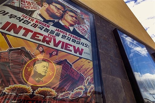 This Dec. 17, 2014, photo shows a movie poster for the movie "The Interview" on display outside the AMC Glendora 12 movie theater, in Glendora, Calif.