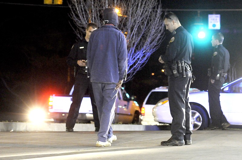 Chattanooga police Officer Mirza Muretcehajic, right center, observes a DUI suspect during a sobriety test at Wilcox and Tunnel boulevards.