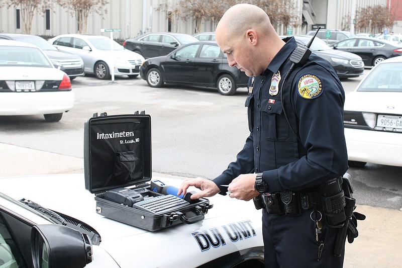 Officer Gary Frisbee demonstrates how the new mobile Intoximeters work while parked at the Police Services Center. Chattanooga police received two of the new units from TBI. 