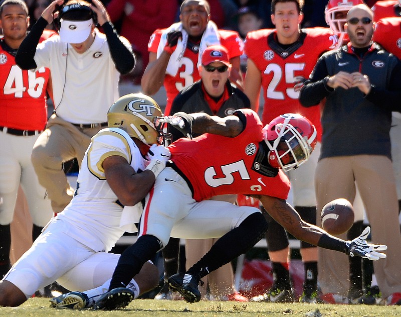 Georgia cornerback Damian Swann (5) almost intercepts a pass intended for Georgia Tech wide receiver DeAndre Smelter, left.