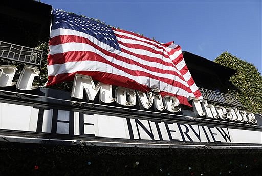 "The Interview," the comedy starring Seth Rogen and James Franco, is listed under an American flag on the marquee of the Cinefamily at Silent Movie Theater in Los Angeles, on Dec. 25, 2014. 