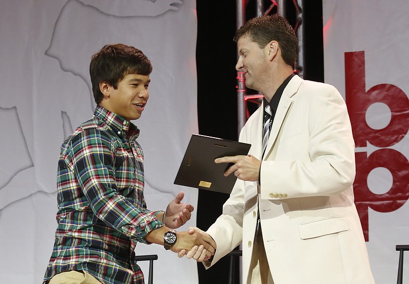 Assistant Sports Editor Stephen Hargis, right, presents Male Athlete of the Year Slade Dale with the football award at the 2014 Best of Preps Banquet on May 29, 2014, at the Chattanooga Convention Center in Chattanooga.