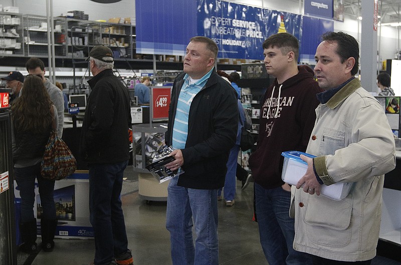 Shoppers wait in line to return items during day-after-Christmas shopping Friday at Best Buy on U.S. Highway 153 in Chattanooga.