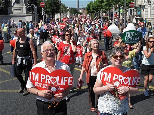 A Saturday, July 6, 2013, file photo shows Stephen and Pauline O'Brien, foreground, holding Catholic rosary beads as they march through Ireland's capital, Dublin, in an anti-abortion protest. 