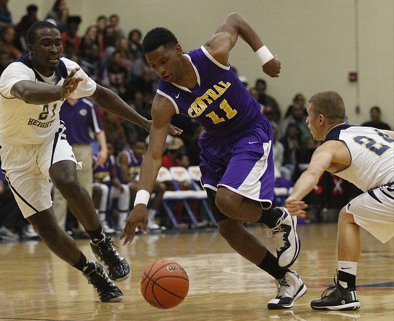 Central's Ryan Montgomery (11) tries to get between Hamilton Heights's Ezekiel Balogun, left, and Milos Andelic during their Best of Preps Basketball Tournament semifinal game Saturday, Dec. 27, 2014, at Chattanooga State Technical Community College.