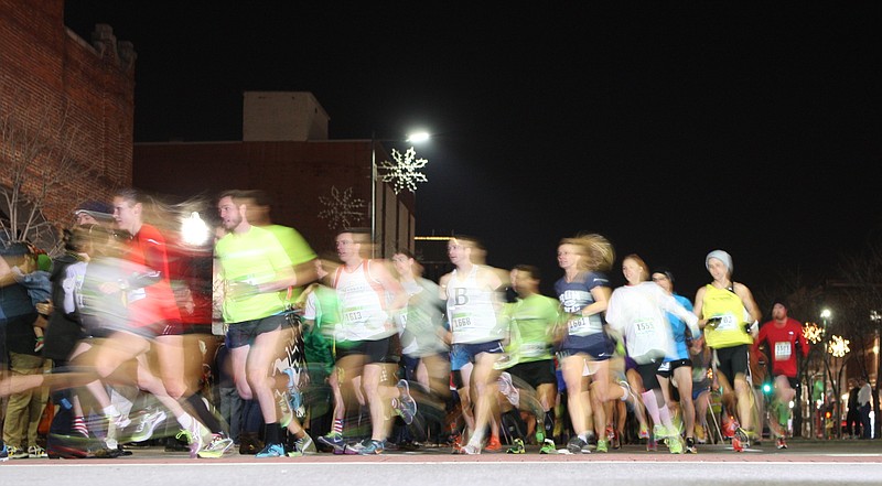 Runners turn the corner from Broad Street onto Third Street at the beginning of the 35th annual Karen Lawrence Run for St. Jude in this New Year's Eve, 2013, file photo.