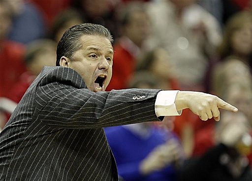 Kentucky coach John Calipari gestures as he directs his top-ranked team against No. 4 Louisville in their game in Louisville, Ky., on Dec. 27, 2014.