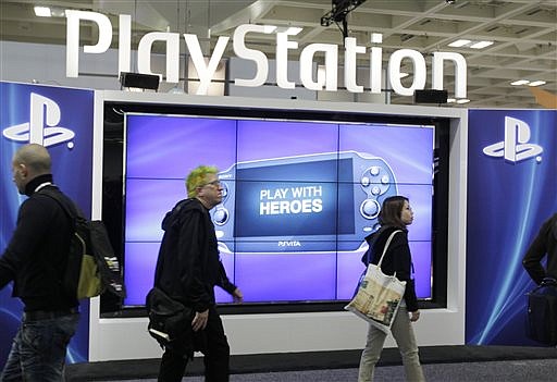 Attendees walking past the Sony PlayStation PS Vita console on display in the Sony PlayStation booth at the Game Developers Conference in San Francisco in this 2012 file photo.