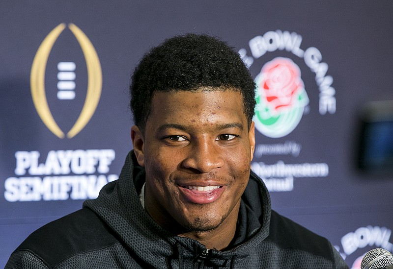 
              Florida State quarterback Jameis Winston smiles as he takes questions during a news conference in Los Angeles, Sunday, Dec. 28, 2014. Florida State takes on Oregon in the Rose Bowl on New Year's Day. (AP Photo/Damian Dovarganes)
            