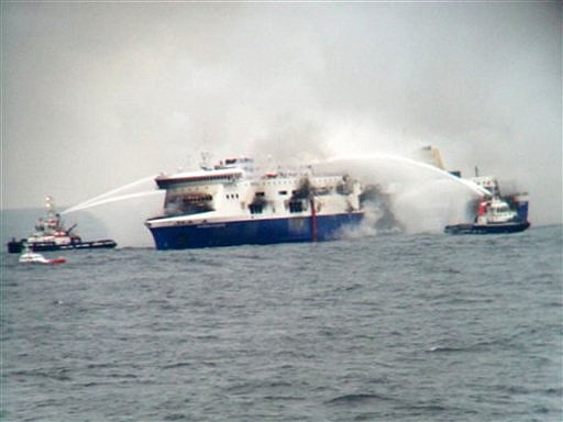 In this photo taken from a nearby ship, vessels try to extinguish the fire at the Italian-flagged Norman Atlantic after it caught fire in the Adriatic Sea on Sunday, Dec. 28, 2014. (AP Photo/SKAI TV Station) 