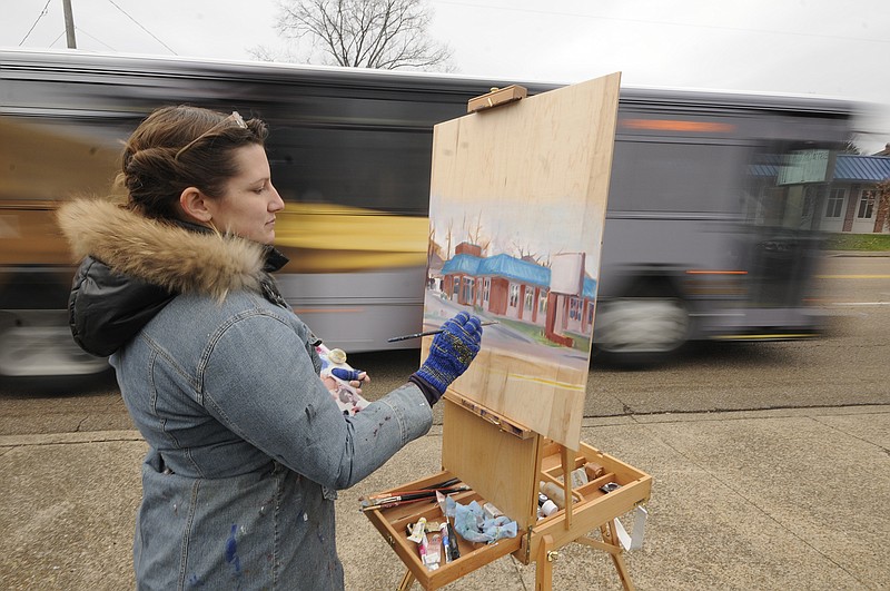 McCallie Avenue traffic passes as Hollie Berry braves 46-degree December temperatures to begin a commissioned work of the Chattanooga landmark Wally's Restaurant. "I'm doing this to match a 1950s photo of the Highland Park eating spot," she said. 