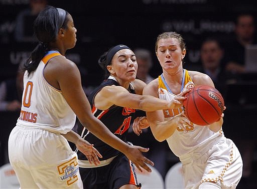 Oregon State guard Gabriella Hanson (11) attempts to steal the ball from Tennessee guard Alexa Middleton (33) as it is passed by Tennessee guard Jordan Reynolds (0) in the first half of an NCAA college basketball game Sunday, Dec. 28, 2014, in Knoxville, Tenn. 