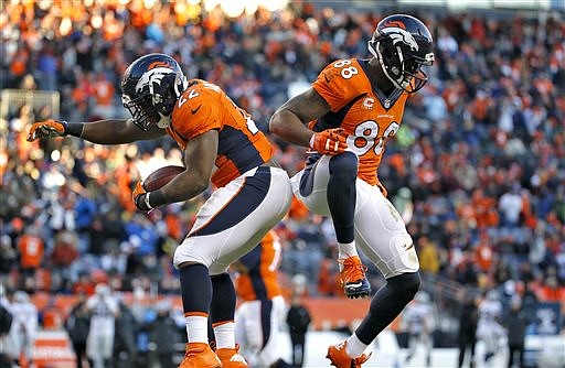 Denver Broncos running back C.J. Anderson celebrates his touchdown against the Oakland Raiders with Demaryius Thomas (88) during their game, Sunday, Dec. 28, 2014, in Denver.