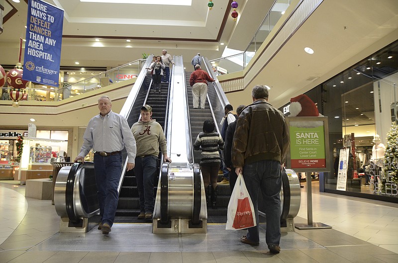 Mall patrons ride the escalator while getting in their Christmas shopping at Hamilton Place Mall in Chattanooga in this December 18, 2014, file photo.