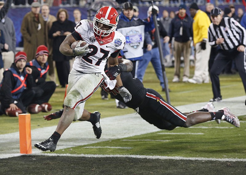Georgia's Nick Chubb (27) runs into the end for a touchdown against Louisville late in the second half of the Belk Bowl NCAA college football game in Charlotte, N.C., Tuesday, Dec. 30, 2014. Georgia won 37-14. Chubb was the game's MVP. 