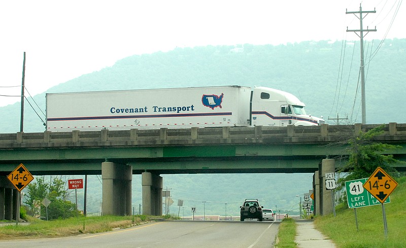 A Covenant Transport truck drives along I-24 over Cummings Highway.