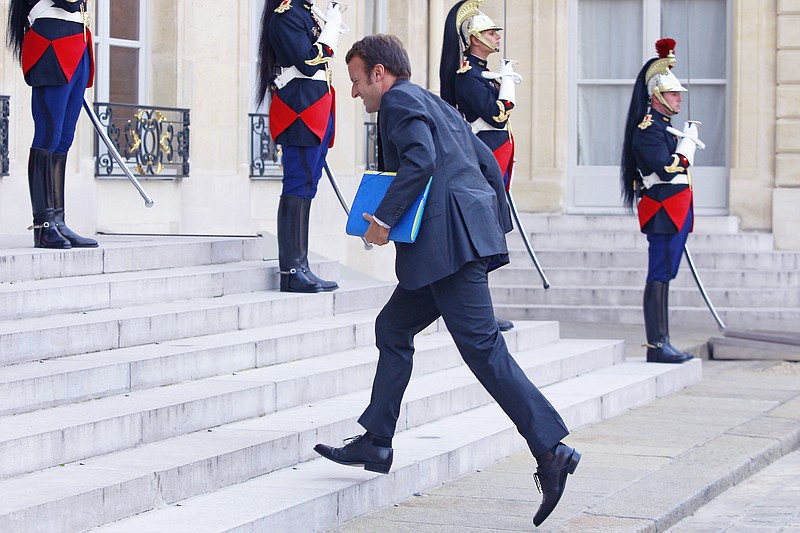 
              FILE - In this Sept. 1, 2014, file photo, French Economy and Industry minister Emmanuel Macron arrives for an official diner with the French President Francois Hollande and Saudi Crown Prince and Defense Minister Salman bin Abdul-Aziz, at the Elysee Palace in Paris, France. The tax of 75 percent on income earned above one million euros ($1.22 million) was promoted in 2012 by the newly-elected Hollande as a symbol of a fairer policy for the middle class, a financial contribution of the wealthiest at a time of economic crisis. Hollande’s super tax was rejected by a court, rewritten and ultimately netted just a sliver of its projected proceeds.(AP Photo/Jacques Brinon, File)
            